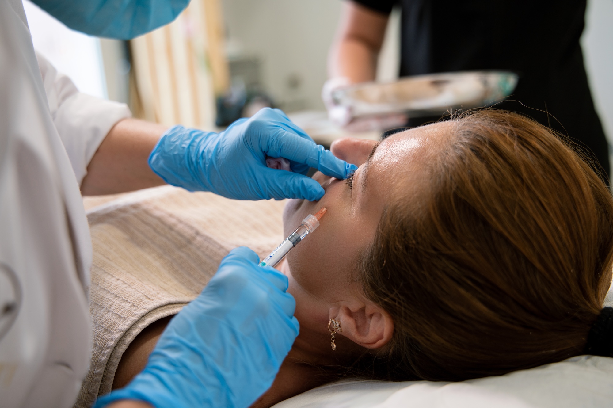 A provider at Vive Aesthetics & Wellness administering a female patient's Botox injections near Medford, NJ.