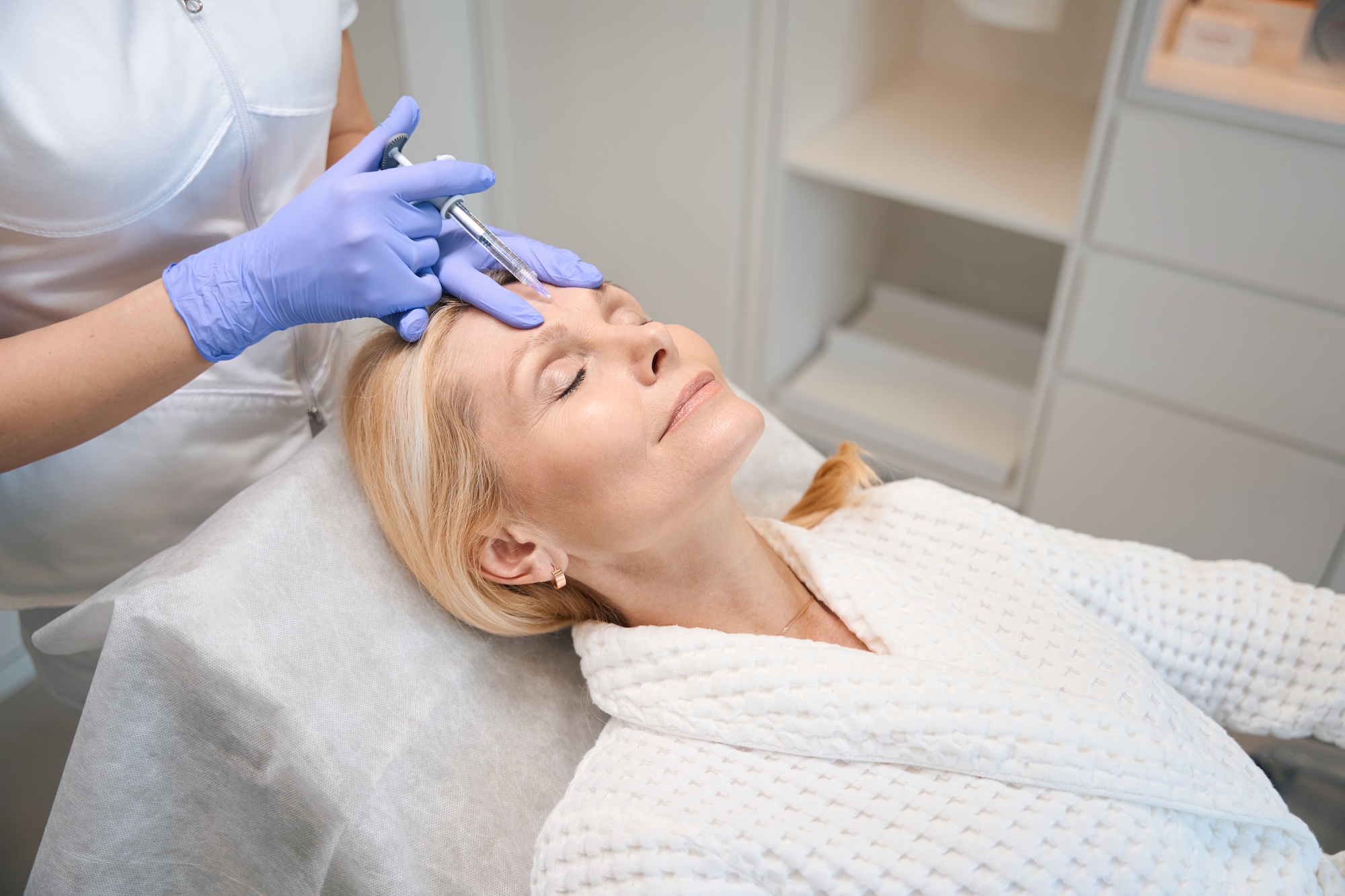 mature blonde female patient at Vive Aesthetics & Wellness receiving injections of Botox near Moorestown, NJ.