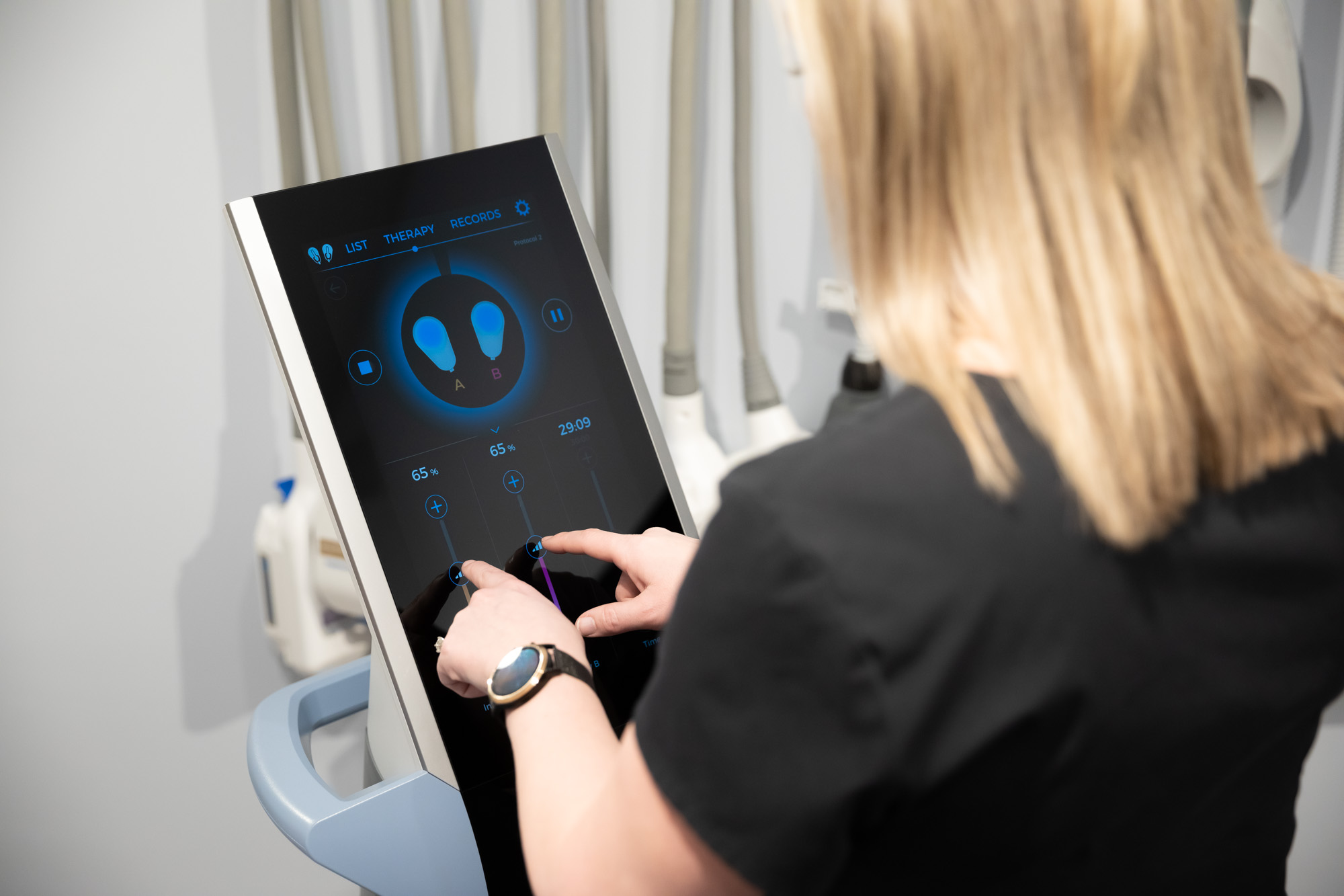 A provider at Vive Aesthetics & Wellness adjusting the treatment settings for Emsculpt near Cherry Hill, NJ.