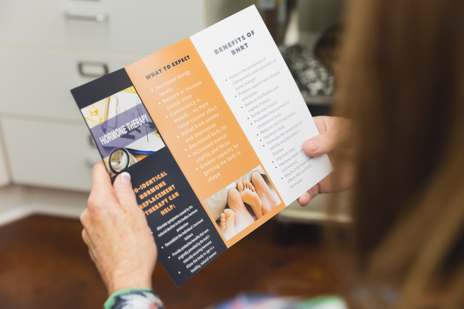 A female patient reads information on BHRT as part of her hormone therapy for menopause in New Jersey. She may add it to her medical weight loss.