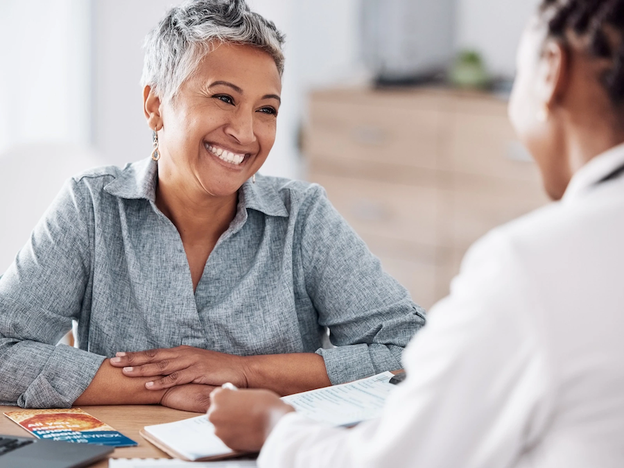 An older female patient at Vive Aesthetics & Wellness smiling at her provider during her routine check in for HRT near Moorestown, NJ.